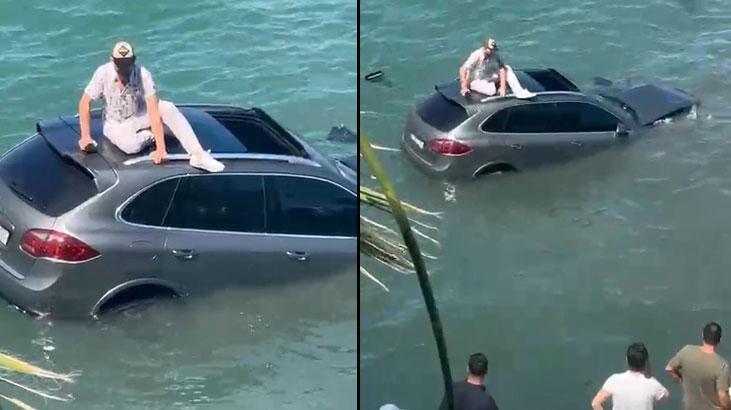 Otomobiliyle denize uçtu, dakikalarca batan aracın üzerinde kurtarılmayı bekledi